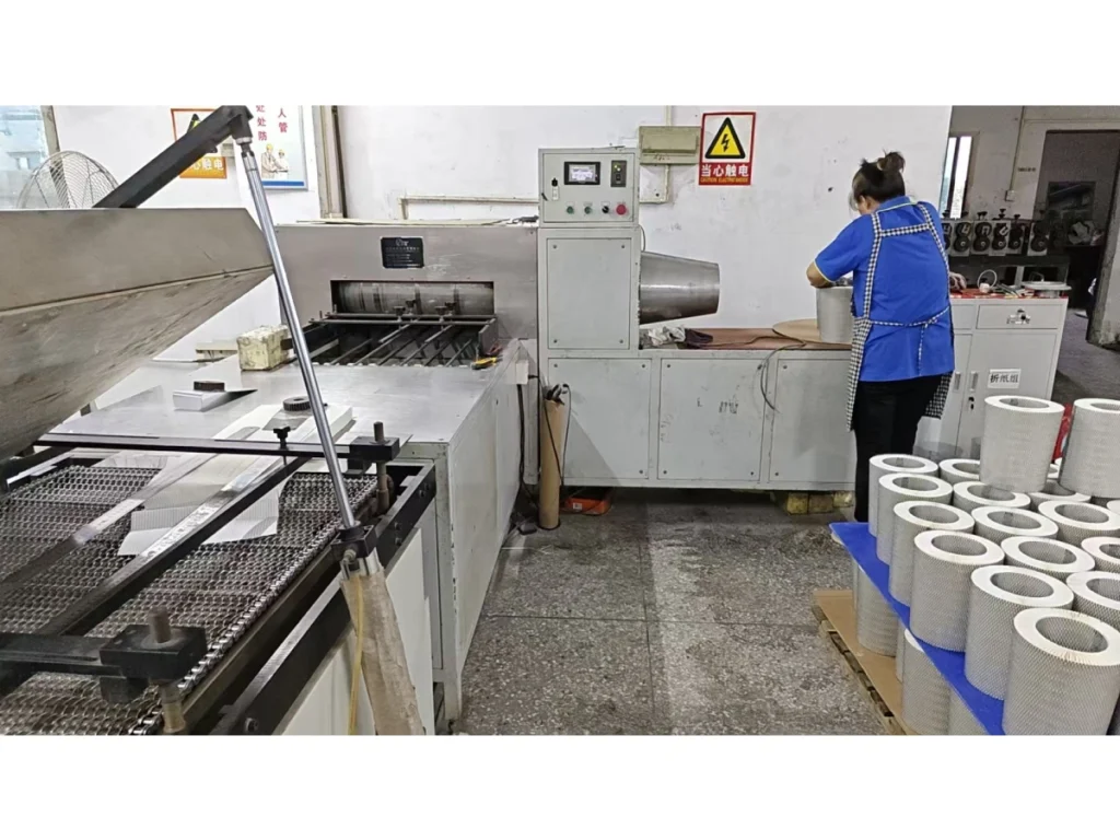 Bowei Factory worker forming metal mesh cylinders for S551/4 air filter production