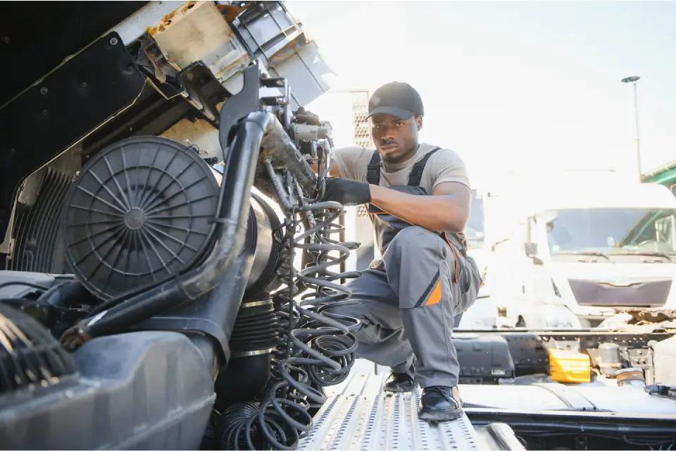 technician inspecting diesel engine air filter in heavy equipment maintenance